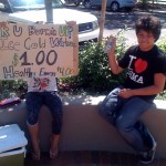 Two people selling cold water outside.