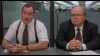 Two men sitting at a table in an office.