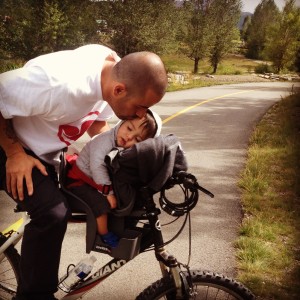 A man and child on a bicycle.