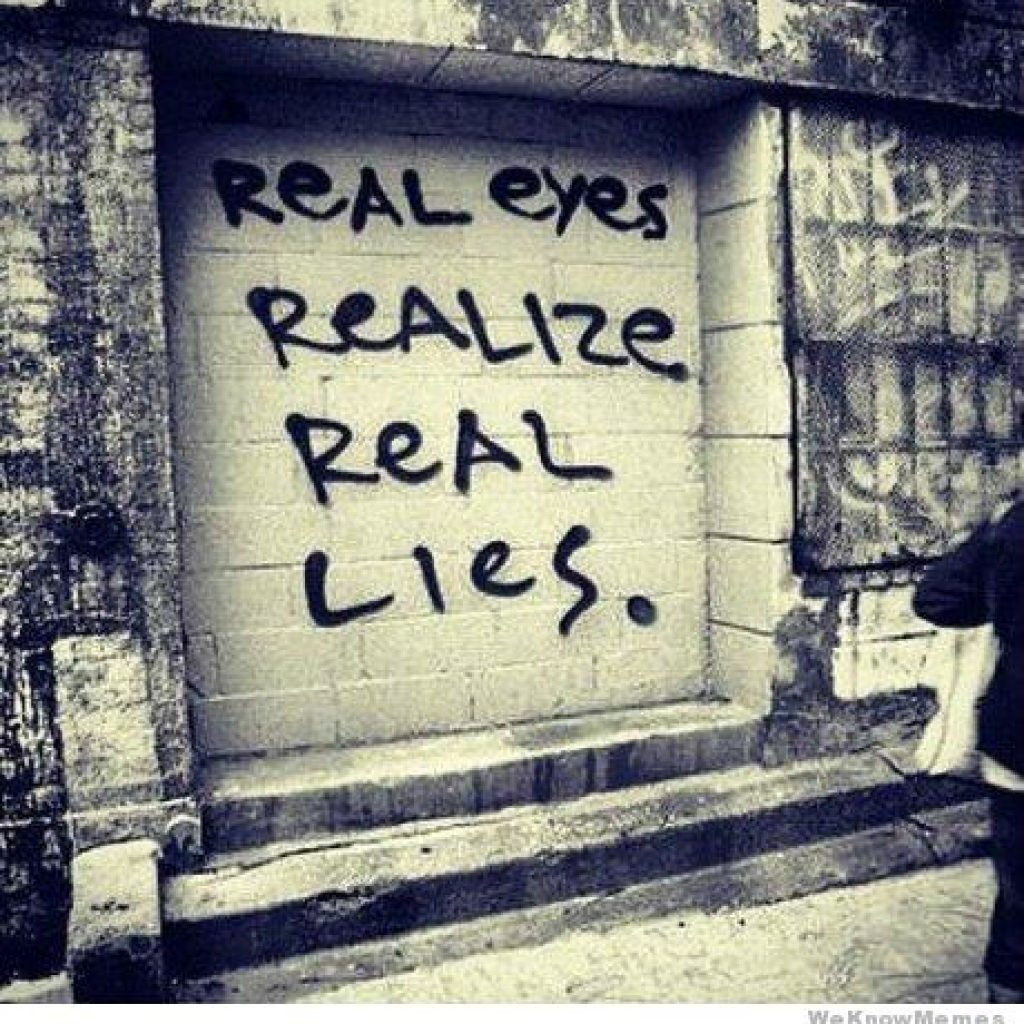 A graffiti wall with the words real eyes realize real lies written on it.